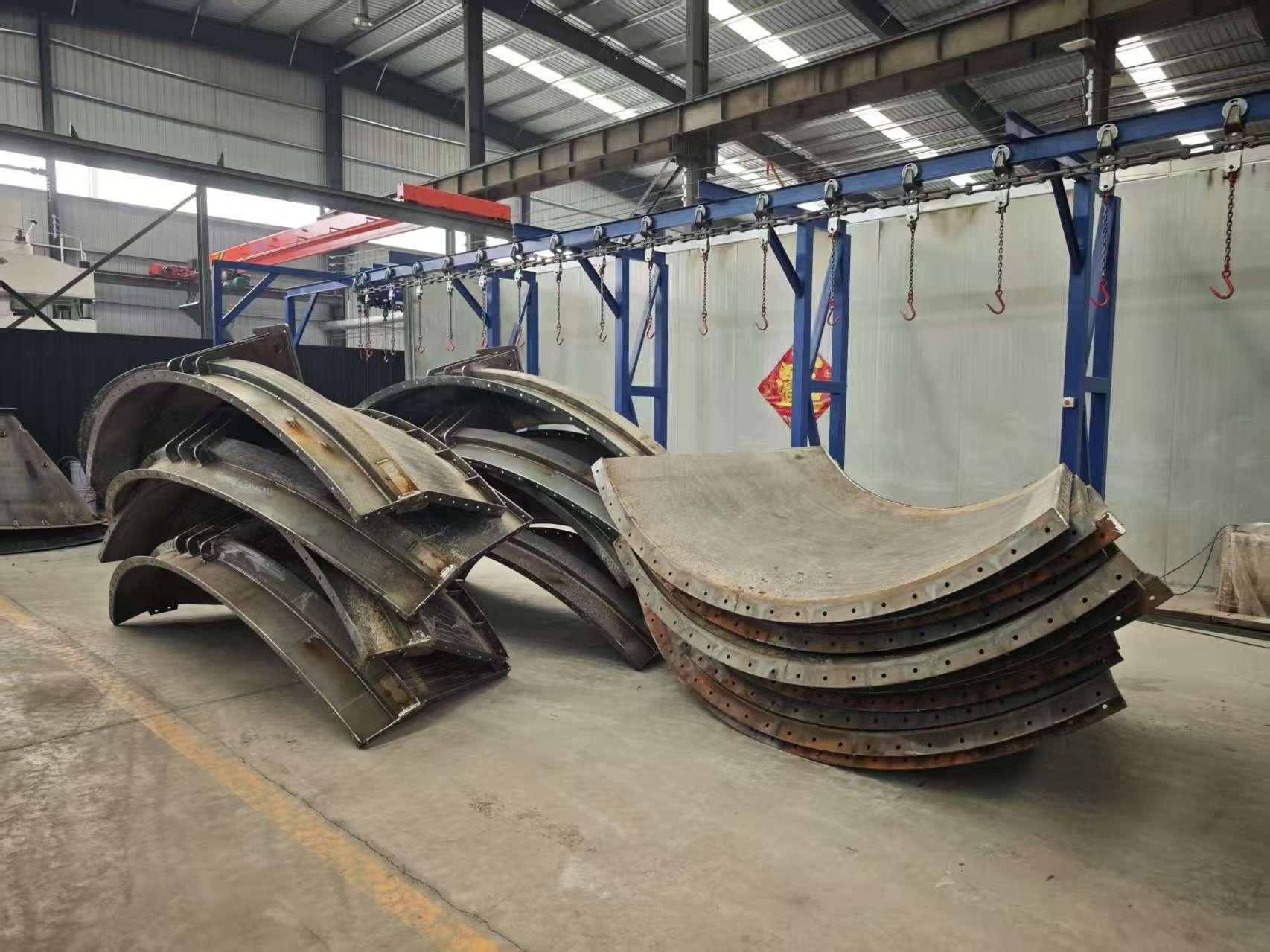 Curved steel silo panels prepared for shipment